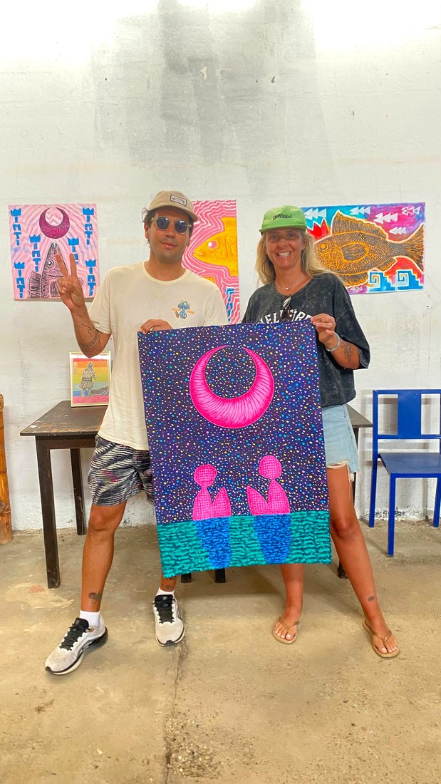 Travelers holding a painting in the studio