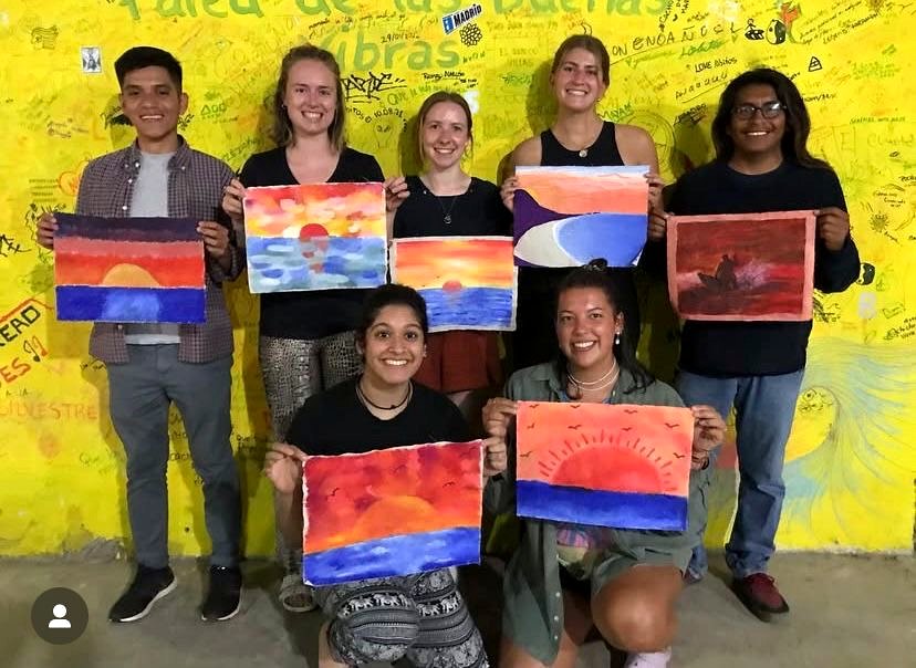 Workshop participants with their paintings
