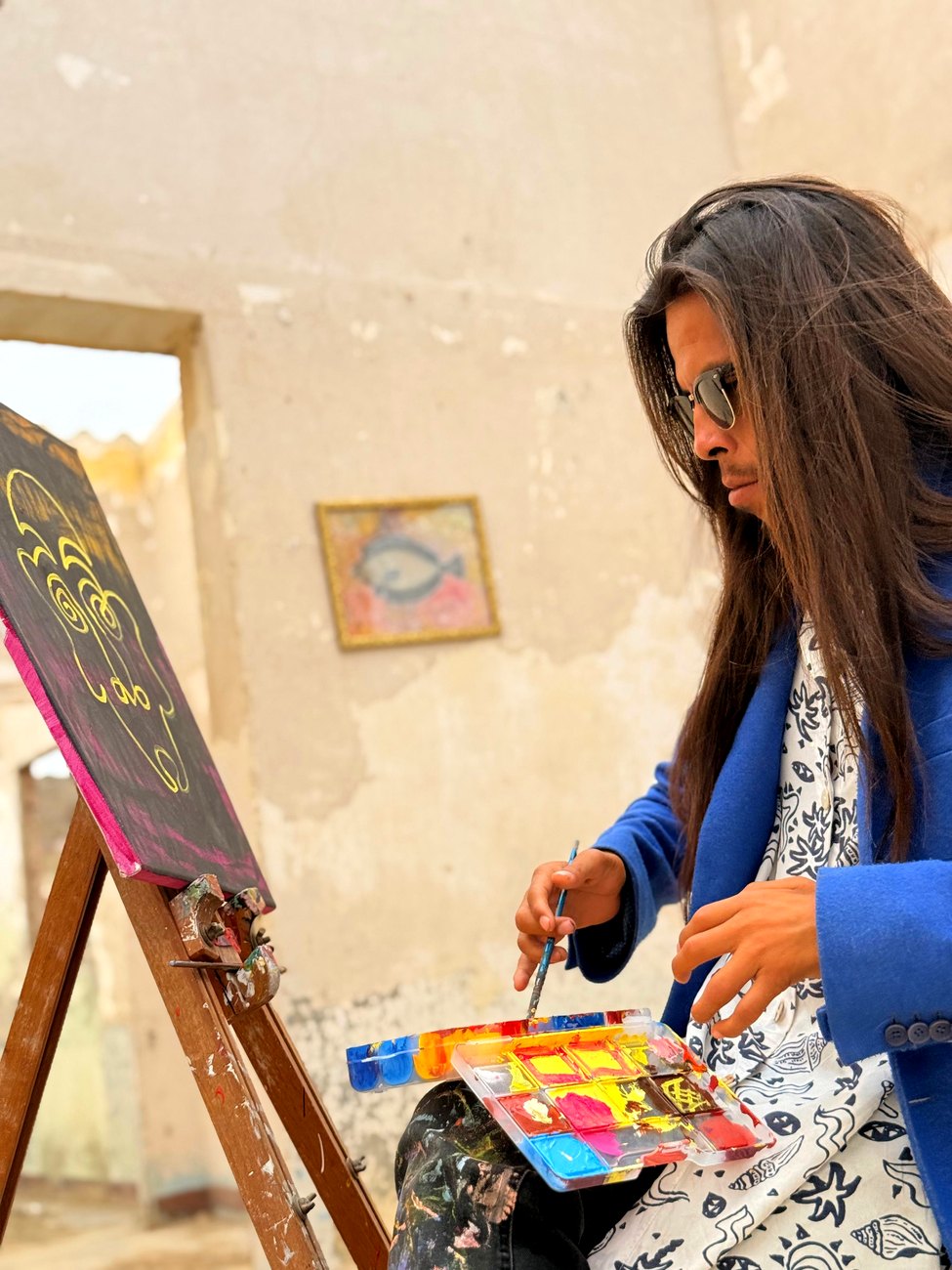 Inti painting at his easel