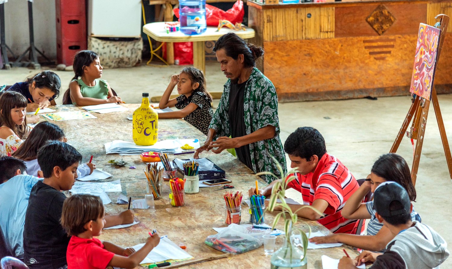Inti leading an art workshop with local children
